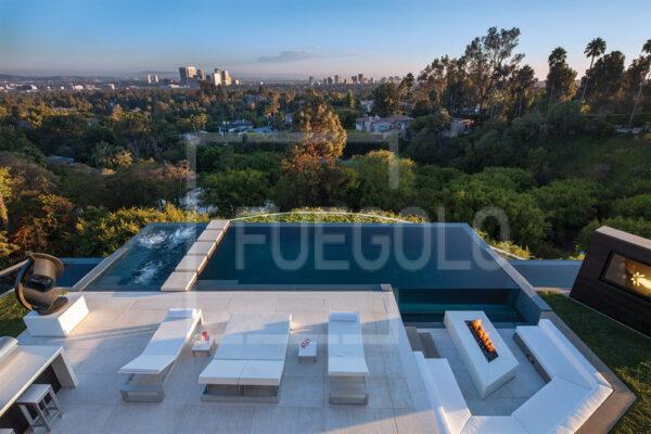 Modern firepit surrounded by seating in a cozy outdoor living space.